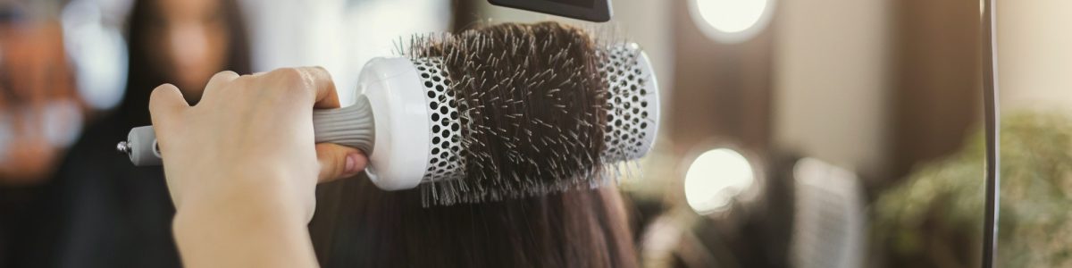 Beautician drying woman's hair